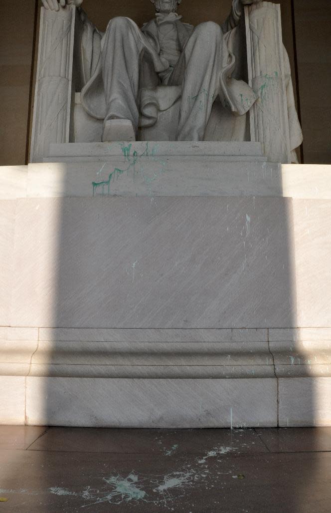 This handout photo provided by the National Park Service shows green paint splatter on the Lincoln Memorial in Washington, Friday, July 26, 2013. The Lincoln Memorial was temporarily closed Friday after someone splattered a splash of green paint on the statue. The apparent vandalism was discovered around 1:30 a.m. Friday on the statue, the pedestal and the floor, U.S. Park Police said. No words, letters or symbols were visible in the paint. (AP Photo/National Park Service)