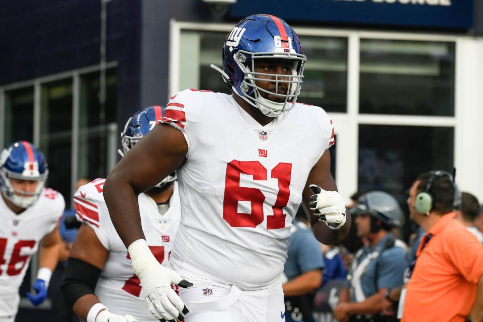 Former Chicago Bears and New York Giants offensive tackle Roy Mbaeteka (61) takes the field for a preseason game.
