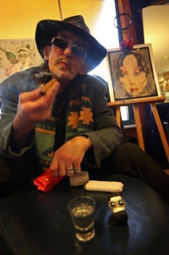 Marcel, nicknamed The Cowboy, smokes a cigar in his living room at Woodstock nursing home for addicts in The Hague, Netherlands, on January 2, 2012. There are 32 other "older" drug and alcohol-dependent residents, including three women, who live at Woodstock, a drab brown apartment block a stone's throw from the city centre