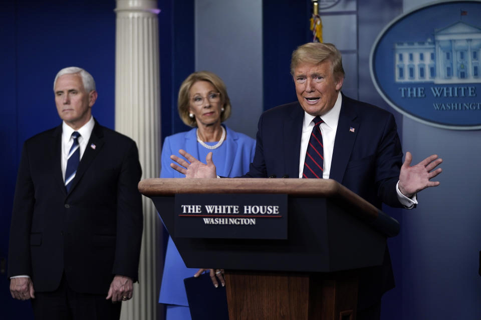 WASHINGTON, DC - MARCH 27:  U.S. President Donald Trump speaks as Vice President Secretary of Education Betsy DeVos and Secretary of Agriculture Sonny Perdue look on during a briefing on the coronavirus pandemic in the press briefing room of the White House on March 27, 2020 in Washington, DC. President Trump signed the H.R. 748, the CARES Act on Friday afternoon. Earlier in the day, the U.S. House of Representatives approved the $2 trillion stimulus bill that lawmakers hope will battle the economic effects of the COVID-19 pandemic.  (Photo by Drew Angerer/Getty Images)