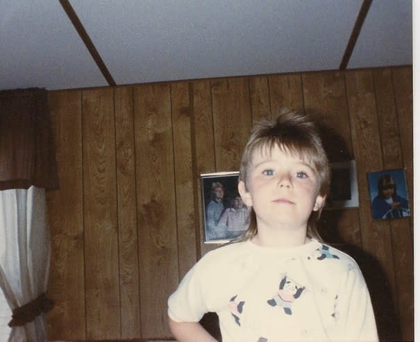 A young child wearing a mullet