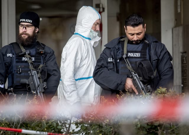 German police officers guard the entrance of a bar where several people were killed in Hanau, Germany