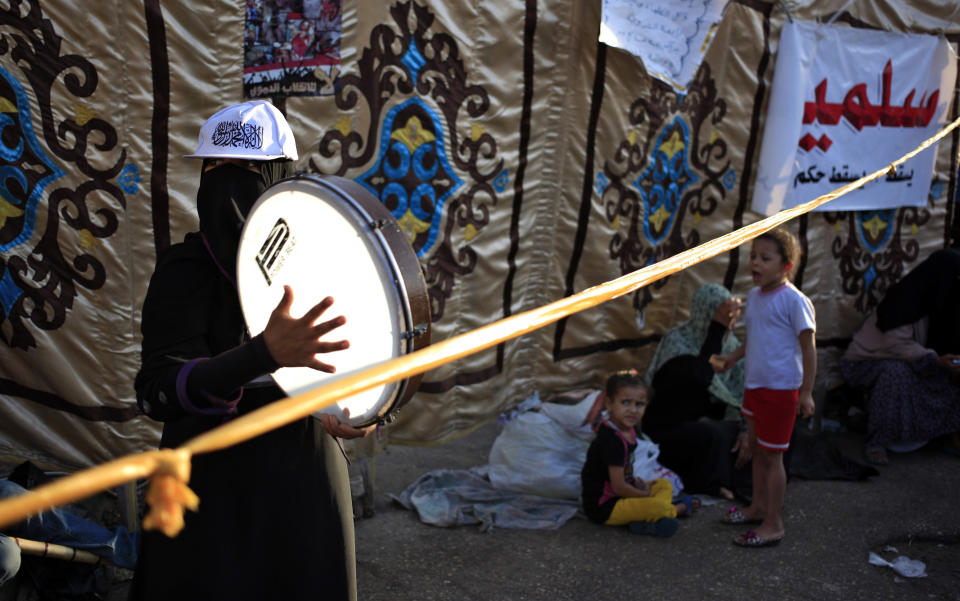 A Supporter of Egypt's ousted President Mohammed Morsi plays drum during a protest outside Rabaah al-Adawiya mosque, where protesters have installed a camp and hold daily rallies at Nasr City in Cairo, Egypt, Thursday, Aug. 1, 2013. (AP Photo/Khalil Hamra)