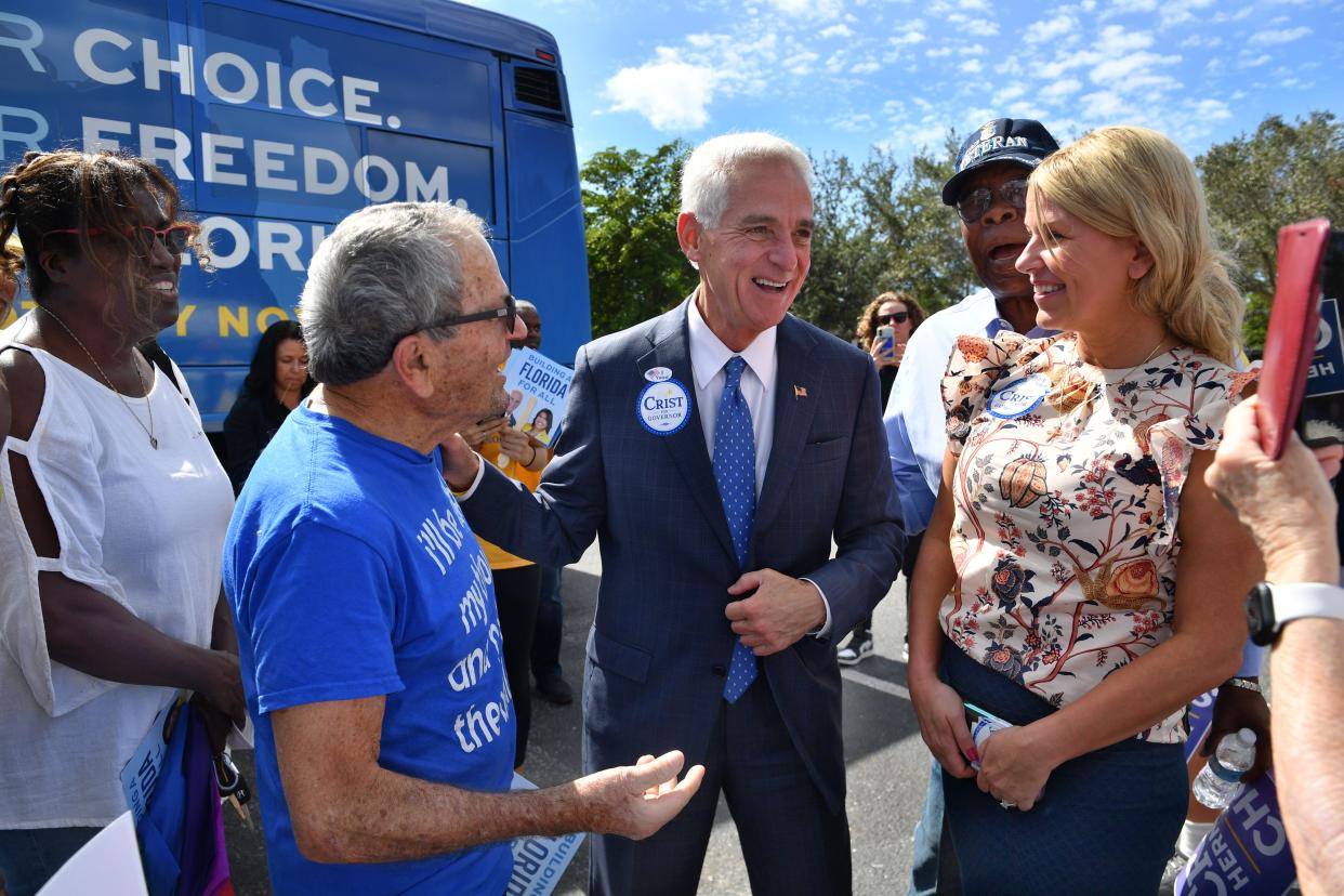 Democratic U.S. Rep. Charlie Crist, center, campaigns for governor Oct. 31 at a Get Out the Vote rally in Sarasota. He brought along his fiancee, Chelsea Grimes, right.