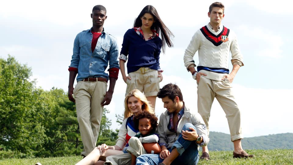 The preppy, "American classical" aesthetic Tommy Hilfiger is best-known for — layering, knits, khakis, sports regalia — pictured here in campaign imagery for his brand's 25th anniversary collection in 2010. - Thomas Iannaccone/WWD/Penske Media/Getty Images