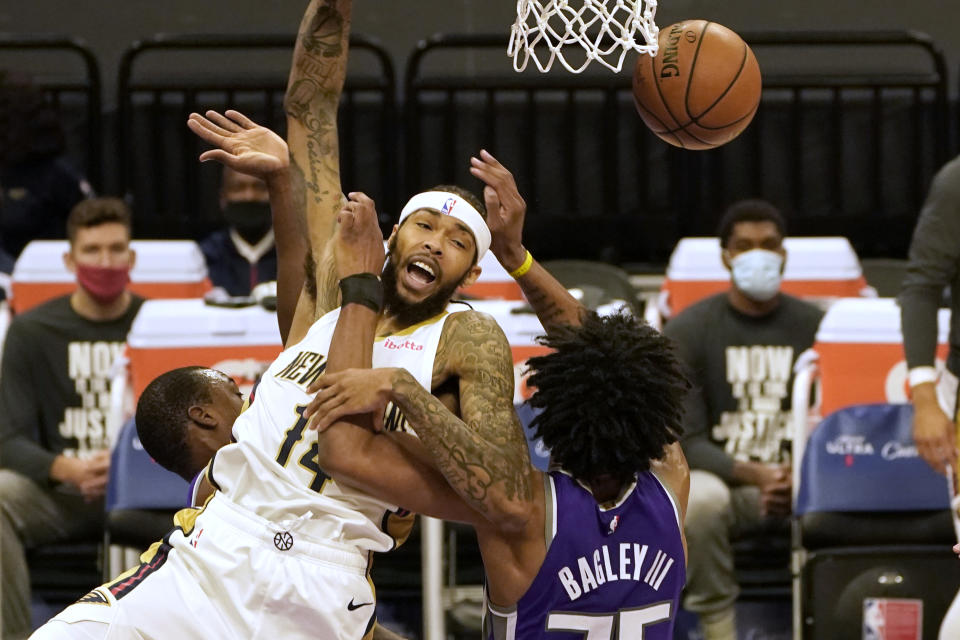 New Orleans Pelicans forward Brandon Ingram, left, is fouled by Sacramento Kings forward Marvin Bagley III during the first quarter of an NBA basketball game in Sacramento, Calif., Sunday, Jan. 17, 2021. (AP Photo/Rich Pedroncelli)