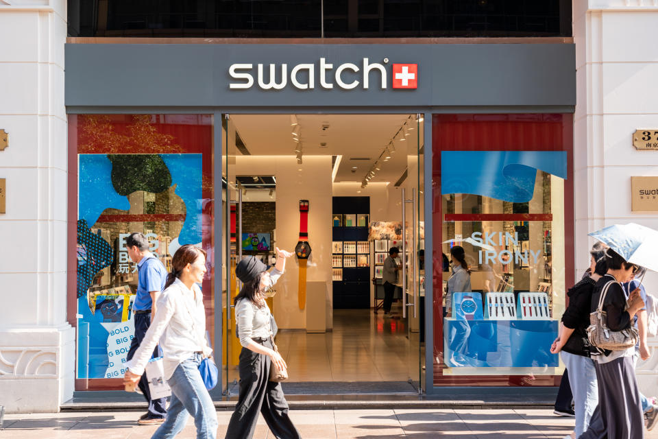 SHANGHAI, CHINA - 2019/09/20: Pedestrians walk past a Swatch store in Shanghai. A Swiss watchmaker. (Photo by Alex Tai/SOPA Images/LightRocket via Getty Images)