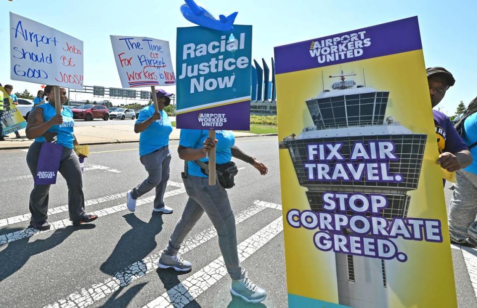 Hundreds of people marched along Wilkinson Boulevard on Tuesday near Charlotte Douglas International Airport. The rally was pushing for a living wage, better working conditions and benefits to be included in the FAA Regulation bill.