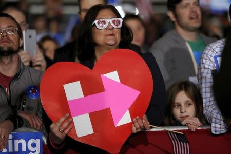 Supporters watch Democratic U.S. presidential candidate Hillary Clinton at a rally at an outdoor plaza in Columbia, South Carolina February 26, 2016. REUTERS/Jonathan Ernst