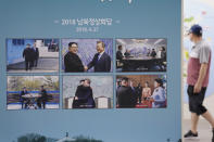 Photos from the April 27, 2018, inter-Korean summit between South Korean President Moon Jae-in and North Korean leader Kim Jong Un are displayed at the Unification Observation Post in Paju, South Korea, near the border with North Korea, Sunday, Sept. 26, 2021. The powerful sister of North Korean leader Kim Jong Un said Saturday that her country will take steps to repair ties with South Korea, and may even discuss another summit between their leaders, if the South drops what she described as hostility and double standards. Korean letters read: " 2018 summit between the South and North Korea." (AP Photo/Ahn Young-joon)