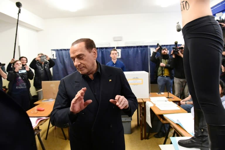 Italian politician Silvio Berlusconi being ambushed by a Femen activist at a voting station on Sunday