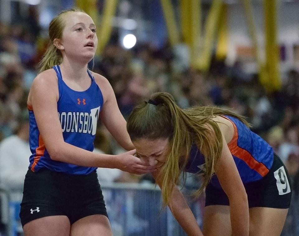 Boonsboro's Caroline Matthews, left, helps teammate Cami Row at the finish line after Matthews won the 3,200-meter run during the Class 1A indoor track and field championships. Row finished fifth.
