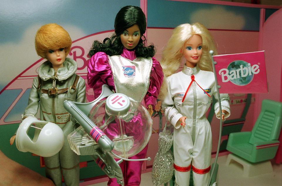 Astronaut Barbie dolls, from left, 1960s, 1980s and 1990s, are on display at the Smithsonian's National Air and Space Museum in Washington, D.C., Monday, May 1, 1995.  (AP Photo/Greg Gibson)