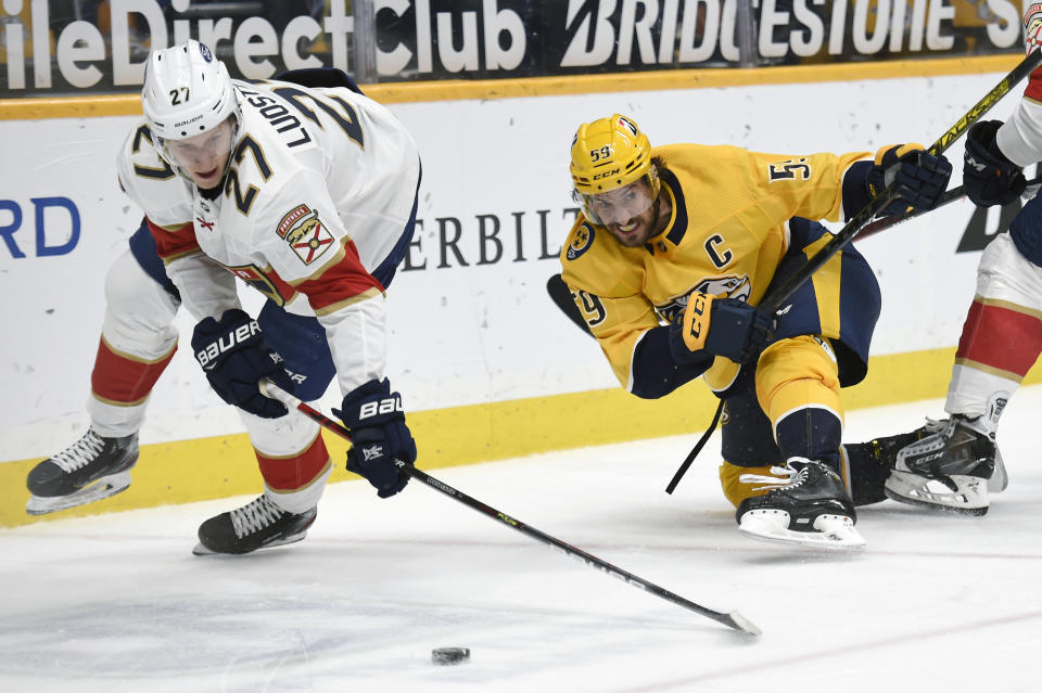 Florida Panthers center Eetu Luostarinen (27) moves the puck in front of Nashville Predators defenseman Roman Josi (59) during the second period of an NHL hockey game Thursday, March 4, 2021, in Nashville, Tenn. (AP Photo/Mark Zaleski)