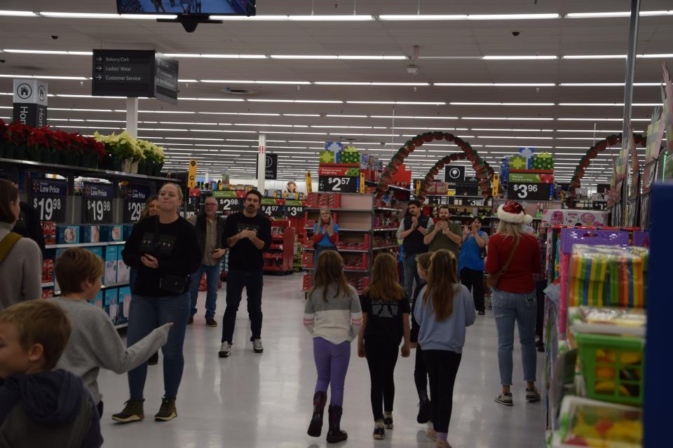 As the Charlevoix Elementary School second graders made their way into the Petoskey Walmart on Monday, Dec. 11, they were greeted with applause from the Walmart staff, as well as parents and other visitors.