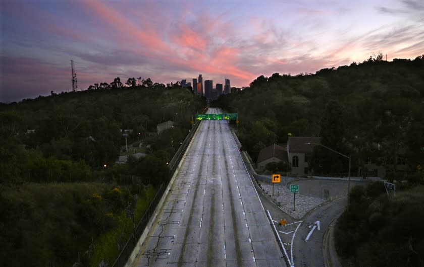 South bound lanes of the 110 Arroyo Seco Parkway leading to downtown Los Angeles are empty during the coronavirus outbreak. At the peak of the pandemic shutdown, global daily carbon dioxide emissions were down 17%, according to a new study.