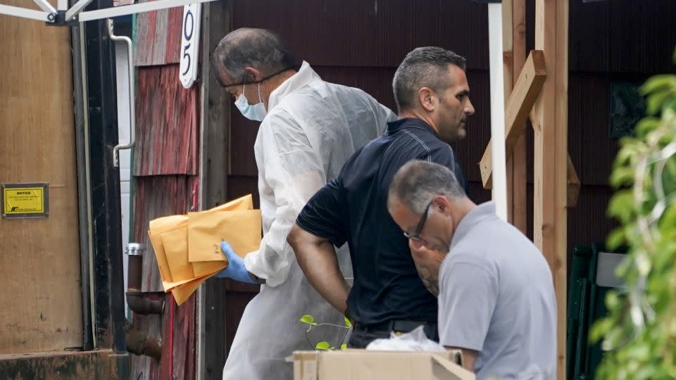 Authorities remove evidence from the Massapequa Park, Long Island, home of suspect Rex Heuermann on Tuesday, July 18. - John Minchillo/AP