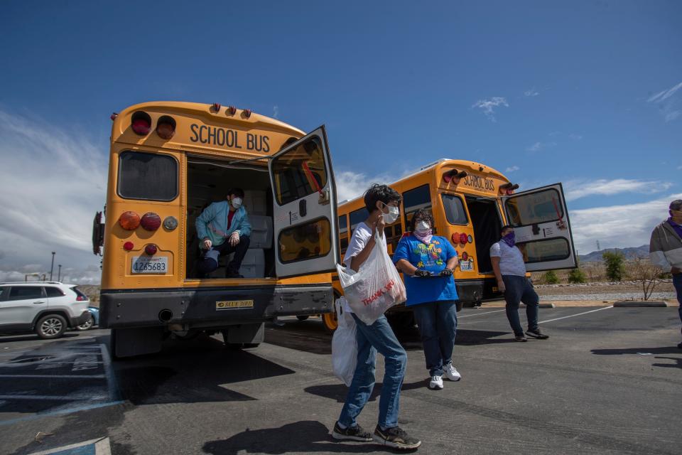 Farmworker families receive food from the Coachella Valley Unified School District in North Shore. Many farmworkers have seen their income reduced and are becoming more dependent on basic food from the school district. 