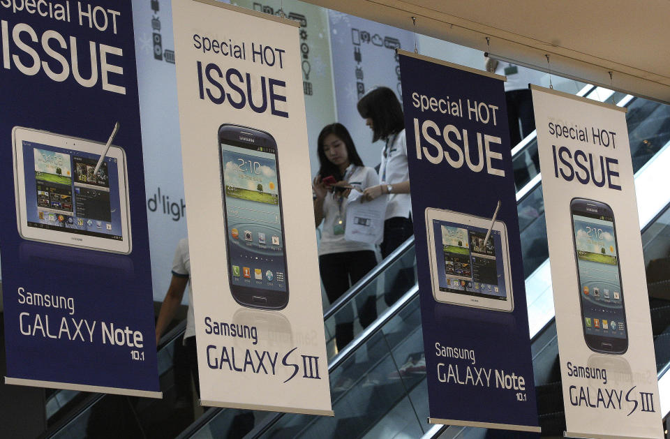 Banners advertising Samsung Electronics' Galaxy S III and Note 10.1 are displayed at the showroom of its headquarters in Seoul, South Korea, Friday, Aug. 24, 2012. The Seoul Central District Court ruled Friday that technology rivals Apple Inc. and Samsung Electronics Co. both infringed on each other's patents, and ordered a partial ban of their products in South Korea. Each side was also ordered to pay limited damages. (AP Photo/Ahn Young-joon)