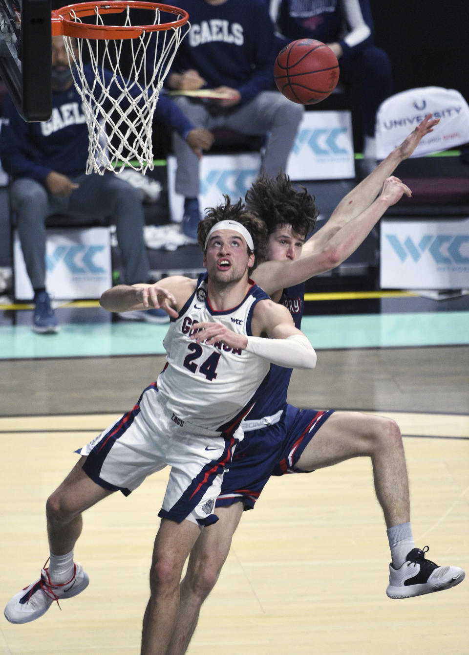 Gonzaga forward Corey Kispert (24) and Saint Mary's forward Kyle Bowen battle for a rebound during the first half of an NCAA semifinal college basketball game at the West Coast Conference tournament Monday, March 8, 2021, in Las Vegas. (AP Photo/David Becker)