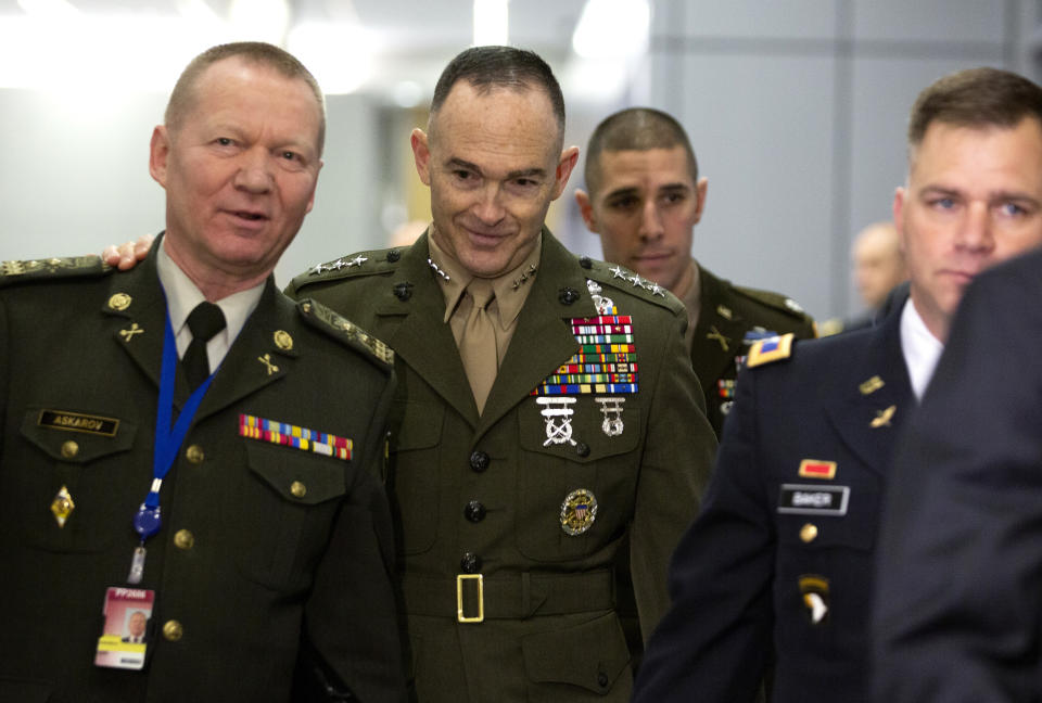 U.S. Marine Lieutenant General and Military Representative John K. Love, center, speaks with Ukraine Military Representative and Lieutenant General Volodymyr Askarov, left, prior to a meeting at NATO headquarters in Brussels, Thursday, Feb. 13, 2020. NATO ministers, in a second day of meetings, will discuss building stability in the Middle East, the Alliance's support for Afghanistan and challenges posed by Russia's missile systems. (AP Photo/Virginia Mayo, Pool)