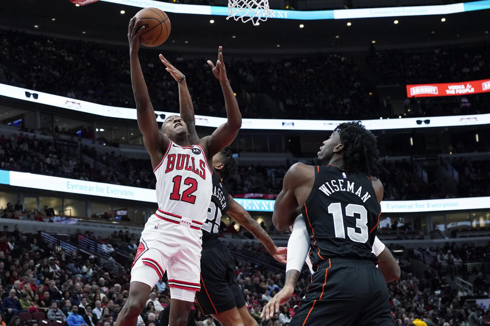 Chicago Bulls guard Ayo Dosunmu, left, drives to the basket against Detroit Pistons guard Marcus Sasser, second from left, during the first half of an NBA basketball game in Chicago, Sunday, Nov. 12, 2023. (AP Photo/Nam Y. Huh)