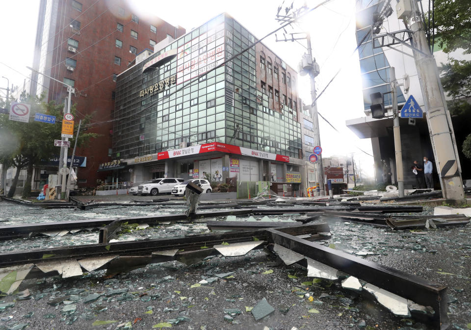 Debris from a damaged hospital caused by typhoon is seen on a street in Ulsan, South Korea, Tuesday, Sept. 6, 2022. Thousands of people were forced to evacuate in South Korea as Typhoon Hinnamnor made landfall in the country's southern regions on Tuesday, unleashing fierce rains and winds that destroyed trees and roads, and left more than 20,000 homes without power. (Kim Yong-tai/Yonhap via AP)