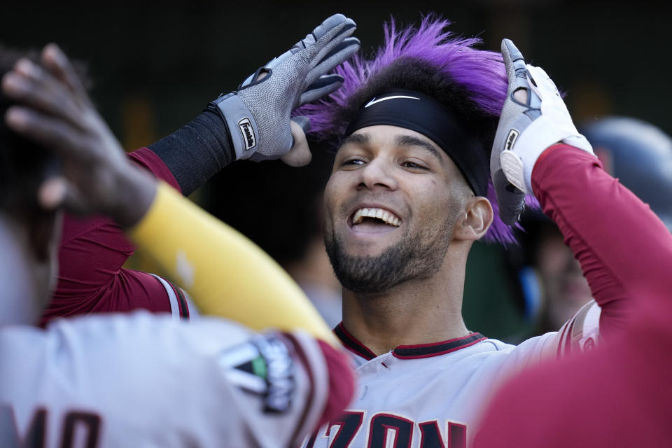 Arizona Diamondbacks' Lourdes Gurriel Jr., celebrates with teammates in the dugout after hitting a two-run home run against the Oakland Athletics during the third inning of a baseball game in Oakland, Calif., Monday, May 15, 2023. (AP Photo/Godofredo A. Vásquez)
