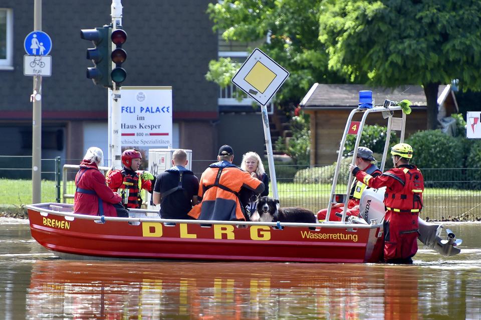 Rescue forces and firefighters evacuate the inhabitants of the In der Lake settlement in Witten, Germany, on Thursday.