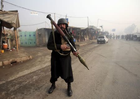 An armed paramilitary soldier stands guard after a suicide bomber blew himself up close to a police checkpoint in Peshawar, Pakistan January 19, 2016. REUTERS/Fayaz Aziz