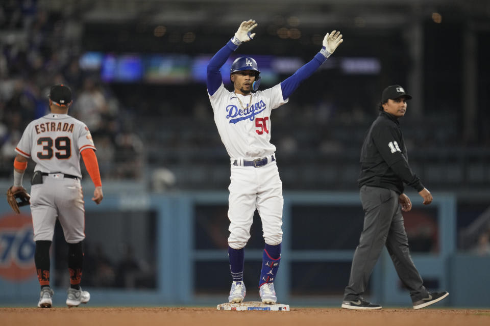 Los Angeles Dodgers second baseman Mookie Betts (50) celebrates after a double during the seventh inning of a baseball game against the San Francisco Giants in Los Angeles, Saturday, Sept. 23, 2023. (AP Photo/Ashley Landis)