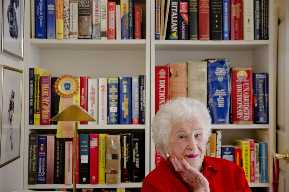 Longtime crossword constructor Bernice Gordon born on Jan. 11, 1914, poses for a portrait with her dictionaries at her home, Tuesday, Dec. 31, 2013, in Philadelphia. The New York Times is scheduled publish one of her puzzles, making her the first centenarian ever to have a grid printed in the paper. Gordon’s feat comes not long after the centennial of the puzzle itself. (AP Photo/Matt Rourke)