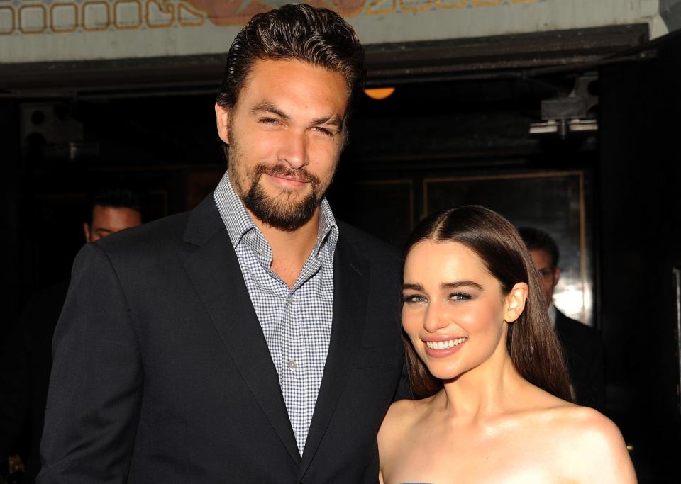 Jason looks formal in a check shirt and blazer while posing next to Emilia