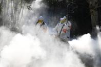 Sanitation workers disinfect a residential compound, as the country is hit by an outbreak of the novel coronavirus, in Bozhou