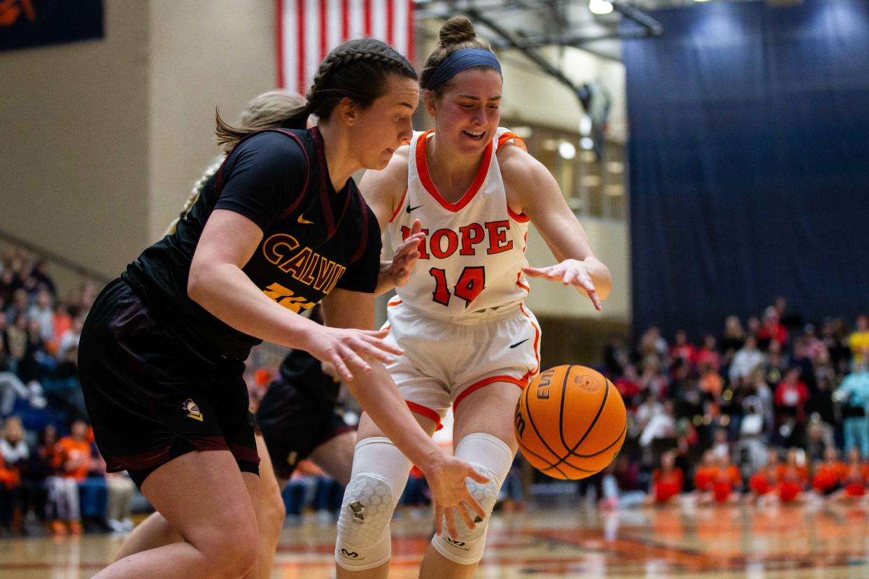 Hope's Kate Majerus reaches for a loose ball as it bounces out of bounds Wednesday, Feb. 8, 2023, at DeVos Fieldhouse. 