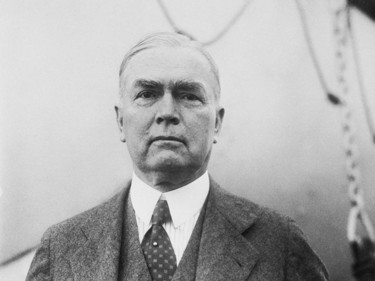 A black and white image of John R. Mott wearing a suit with a patterned tie.