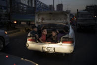 Afghan boys ride in the trunk of a car in Kabul, Afghanistan, Sunday, Sept. 26, 2021. (AP Photo/Felipe Dana)