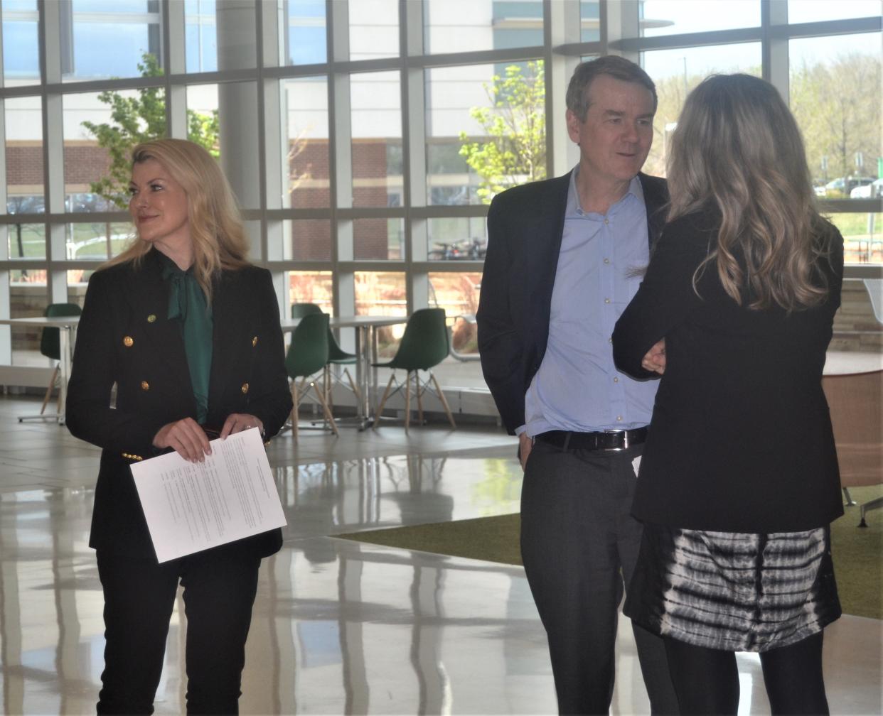 U.S. Sen. Michael Bennet speaks to Kim Jordan, chair of the Colorado State University System Board of Governors, as CSU-Fort Collins President Amy Parsons and Bennet prepare for a news conference Friday, May 5, 2023, at CSU's C. Wayne McIlwraith Translational Medicine Institute in Fort Collins, Colo.