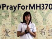 In Malaysia betet eine Buddhistin für die vermissten Insassen von Flug MH370. Foto: Azhar Rahim