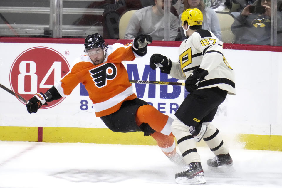 Pittsburgh Penguins' Rickard Rakell (67) checks Philadelphia Flyers' Ivan Provorov off the puck during the first period of an NHL hockey game in Pittsburgh, Saturday, March 11, 2023. (AP Photo/Gene J. Puskar)