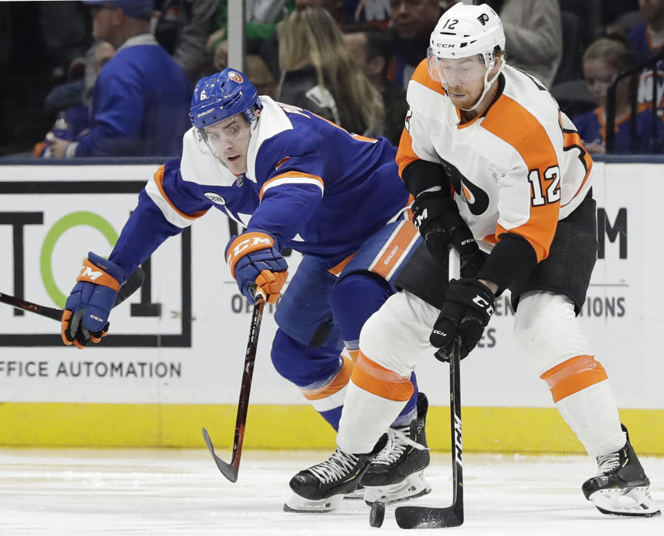 New York Islanders defenseman Ryan Pulock (6) defends Philadelphia Flyers left wing Michael Raffl (12) during the second period of an NHL hockey game, Sunday, March 3, 2019, in Uniondale, N.Y. (AP Photo/Kathy Willens)