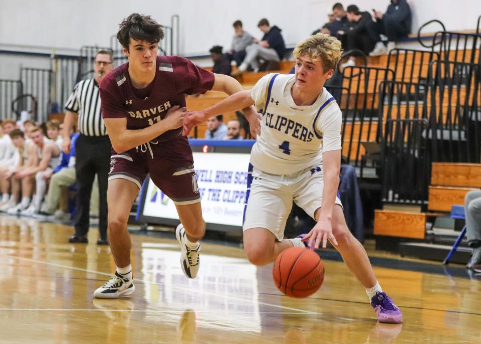Norwell's Ronan Coffey drives past Carver's Robbie Peterson during a game at Norwell High School on Tuesday, Jan. 16, 2024.