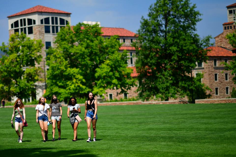 Incoming freshmen walk through campus after moving into dormitories at University of Colorado Boulder on Aug. 18, 2020. Due to COVID, many colleges and universities are using different strategies, with even students living on campus attending all classes remotely.