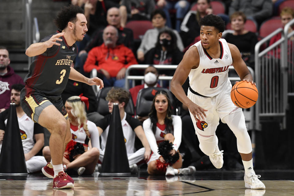 Louisville guard Noah Locke (0) drives around Boston College guard Jaeden Zackery (3) during the first half of an NCAA college basketball game in Louisville, Ky., Wednesday, Jan. 19, 2022. (AP Photo/Timothy D. Easley)