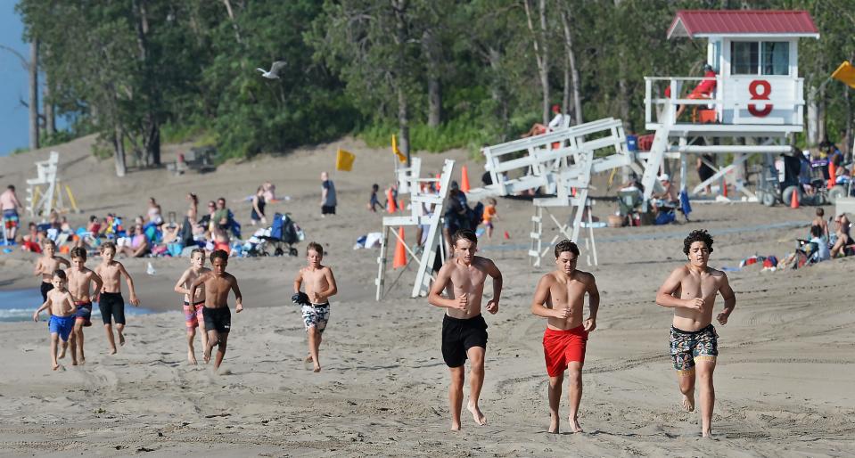 Members of the Rambler Wrestling Club begin a workout at Presque Isle State Park by jogging back from Beach 8, background, to Beach 7. Older wrestlers include incoming Cathedral Prep freshmen Bode Terry, center, and Ethen Ringer, both 14, and junior Bo Martucci, 16, far right.
