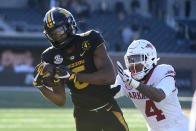 Missouri wide receiver Keke Chism, left, catches a pass as Arkansas defensive back Malik Chavis defends during the second half of an NCAA college football game Saturday, Dec. 5, 2020, in Columbia, Mo. (AP Photo/L.G. Patterson)