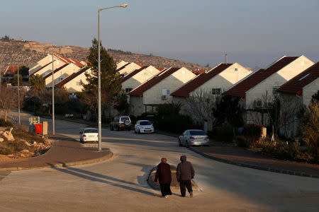 People walk near houses in the Israeli settlements of Ofra, in the occupied West Bank February 6, 2017. REUTERS/Baz Ratner