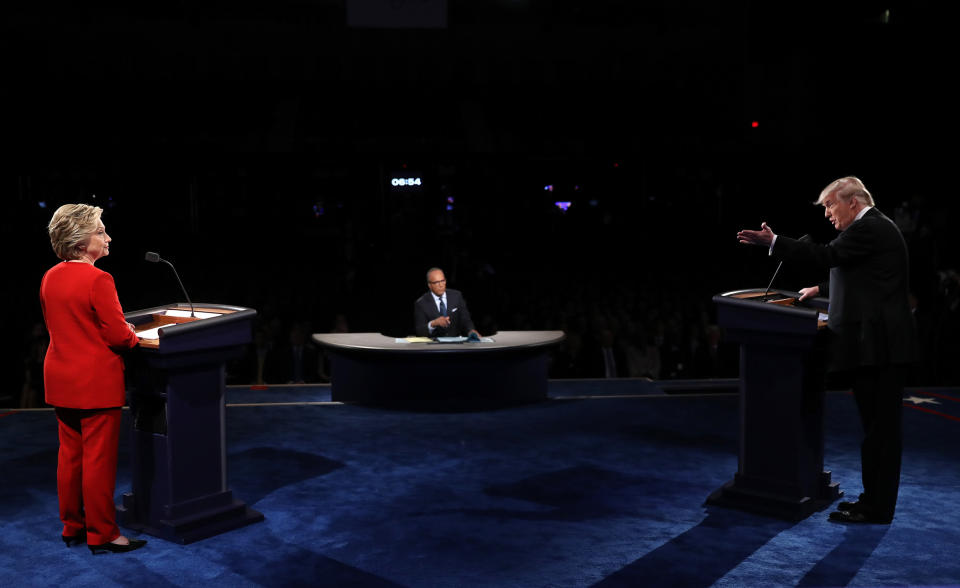 Republican presidential nominee Donald Trump speaks as Democratic presidential nominee Hillary Clinton and Moderator Lester Holt listens during the Presidential Debate at Hofstra University on Sept. 26, 2016.