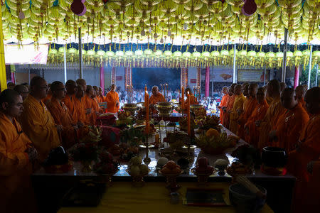 Buddhist monks pray at a temple to mark the eve of the vegetarian festival in Bangkok's Chinatown, Thailand, October 19, 2017. REUTERS/Athit Perawongmetha