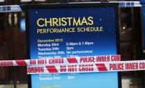 Police tape is wrapped around a notice board outside the Apollo theatre on the morning after part of it's ceiling collapsed on spectators as they watched a performance, in central London, December 20, 2013. Emergency services said nearly 90 people were injured on Thursday when part of the ceiling collapsed during a performance at a packed London theatre, bringing the city's West End entertainment district to a standstill. The audience was showered with masonry and debris following the incident at the Apollo Theatre, where about 720 people including many families were watching the hugely popular play "The Curious Incident of the Dog in the Night-Time". REUTERS/Suzanne Plunkett (BRITAIN - Tags: DISASTER ENTERTAINMENT)